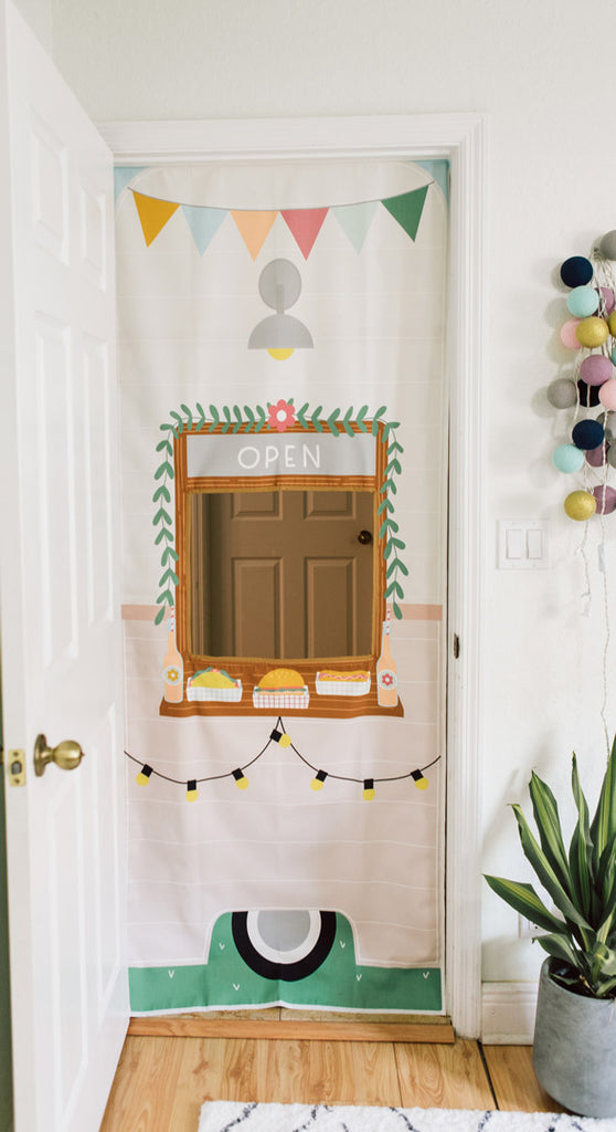 Entrepreneurial toys for kids ideas 2022 Pretend play Food truck playhouse that hangs in playroom doorway. Illustrated with the nostalgia of a camper food truck with colorful banner and string lights. 