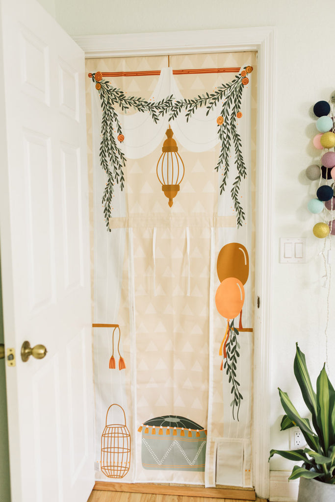 Boho style tea party illustrated with vines, pouf, balloons to inspire pretend play. Sophisticated playroom design ideas