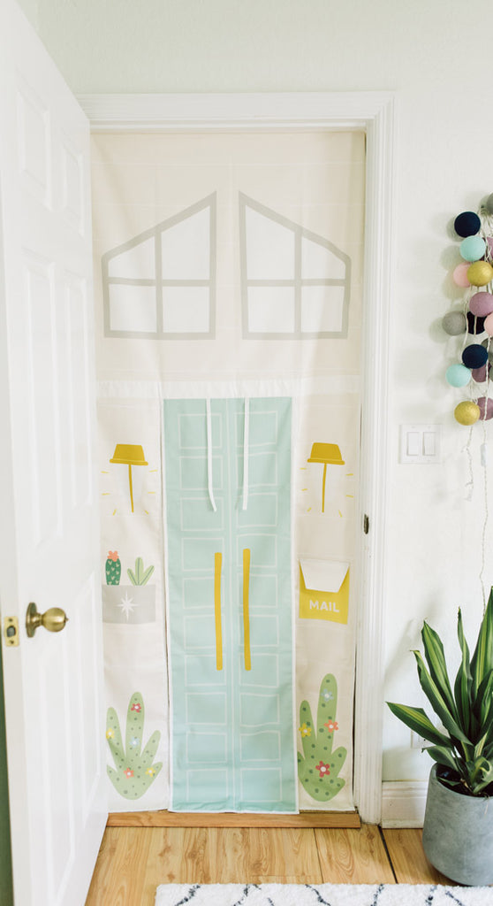 Doorway playhouse inspired by Malibu style houses.  Roll up doors and mailbox inspires play. Kids activity room design playroom ideas